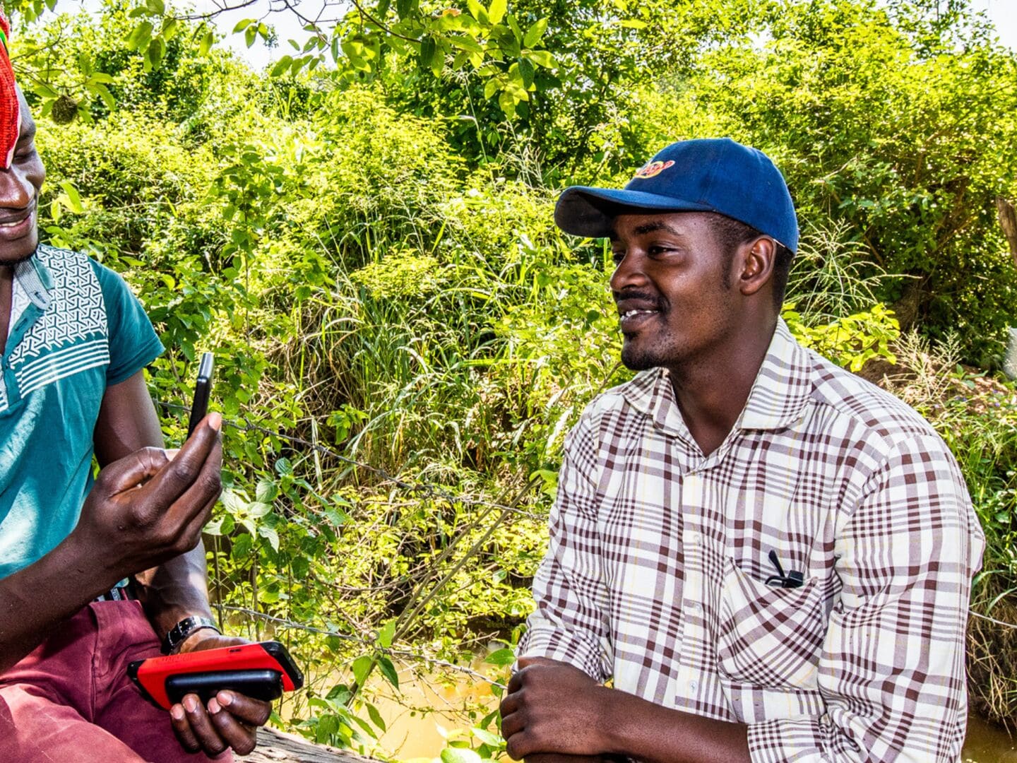 Smallholder farmers in Africa working with a mobile phone