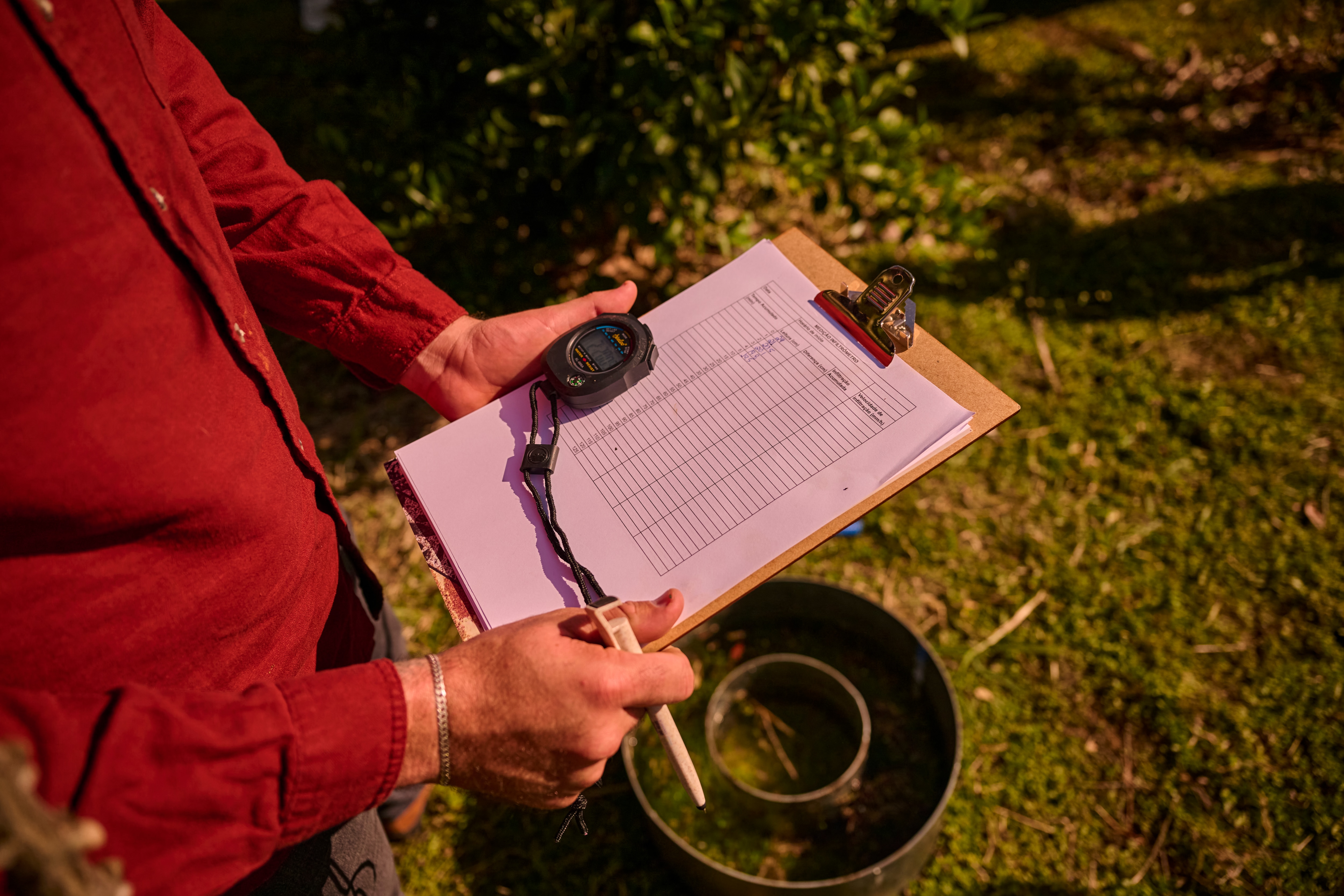 close up of a clipboard held in the hands of a farmer