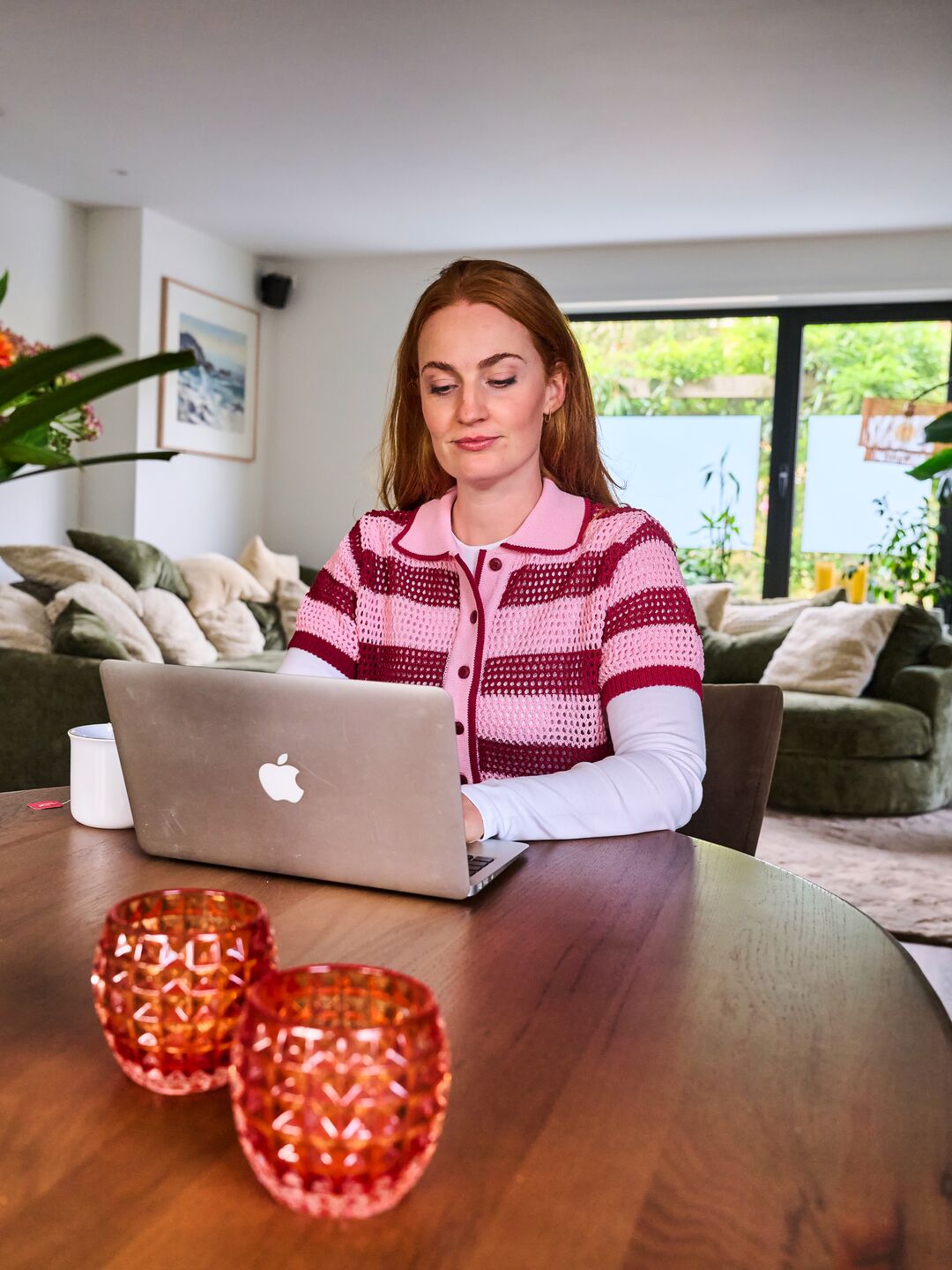 woman behind her laptop managing her banking in her living room