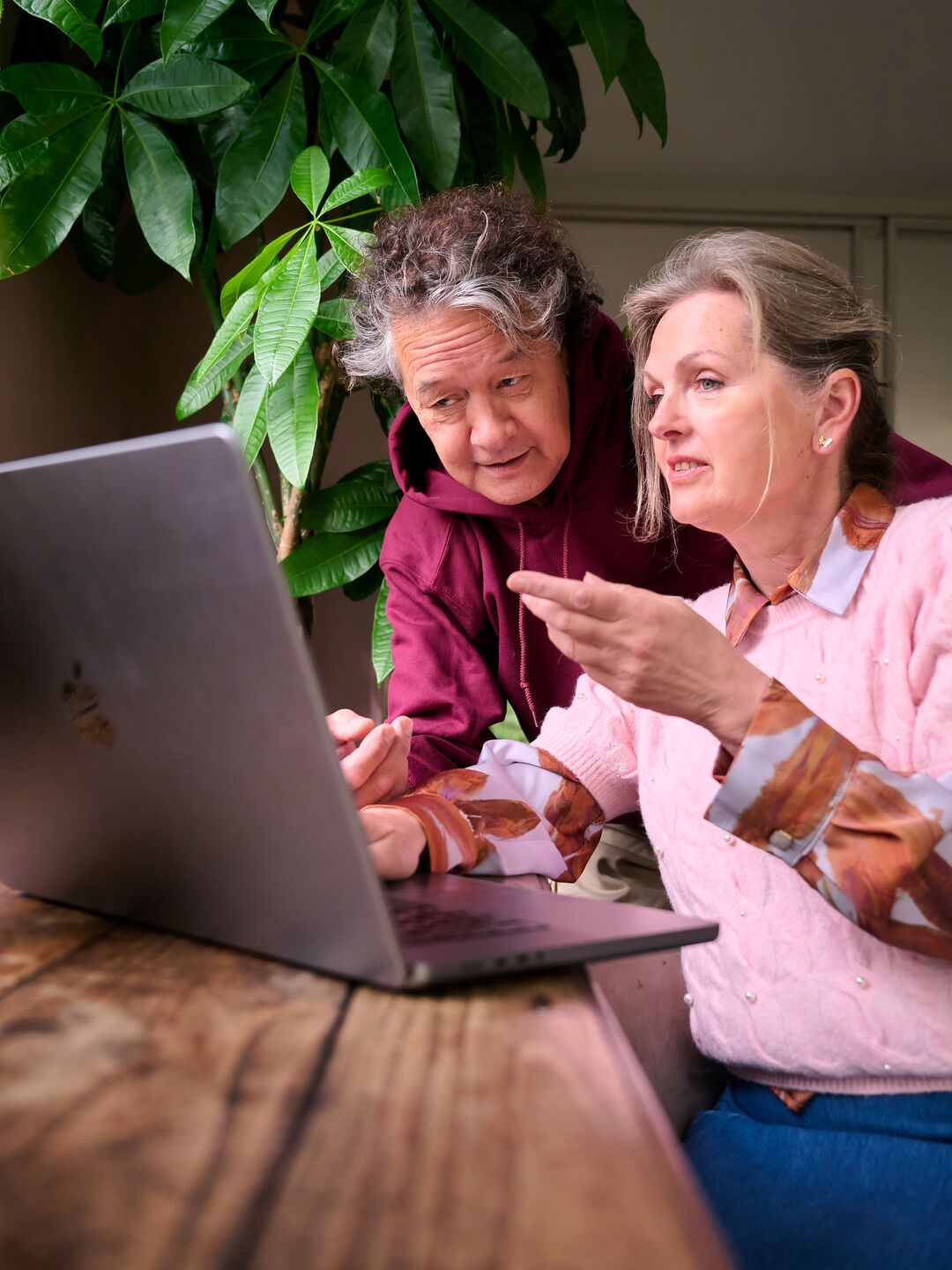 Two women looking at a laptop together.