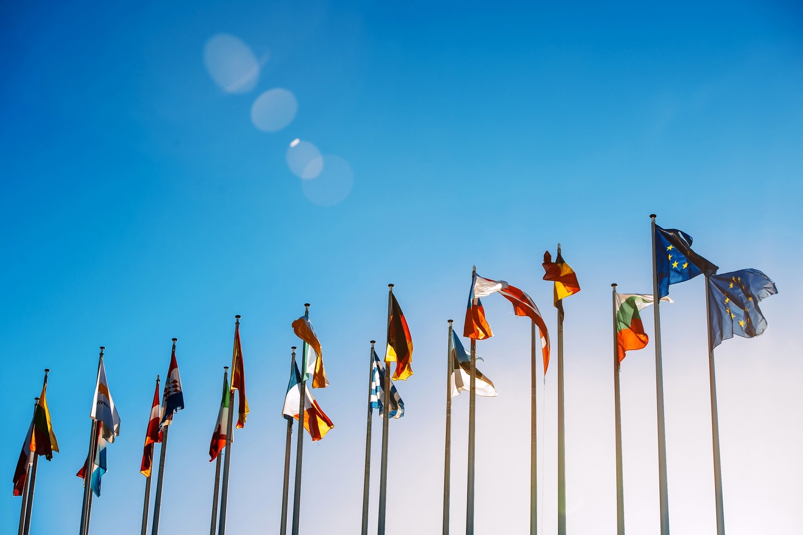 Flags in front of the European Parliament against beautiful blue sky in Strasbourg, Alsace, France