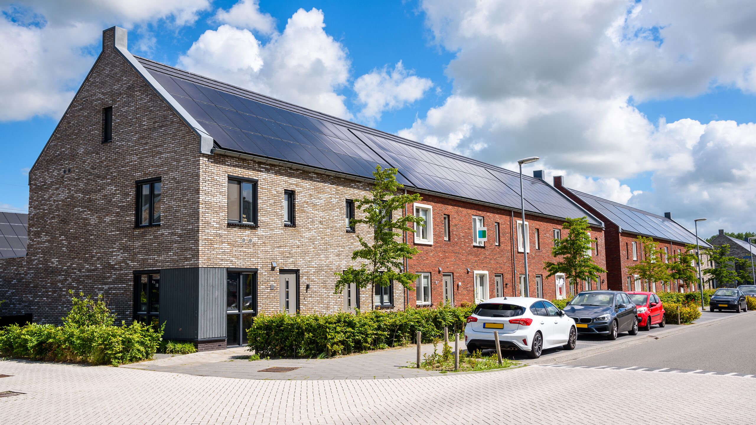 Residential street with houses equipped with rooftop solar panels