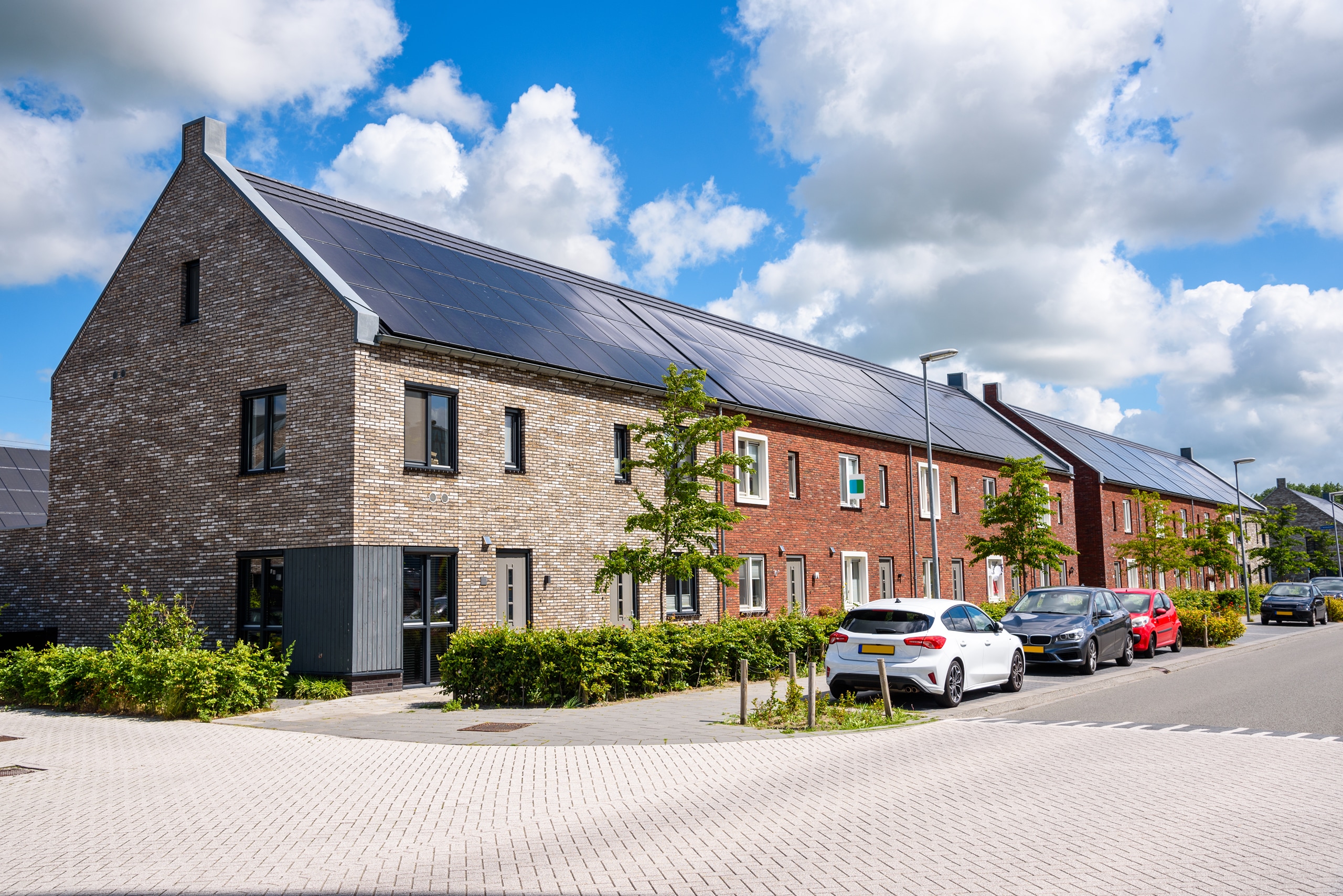 Residential street with houses equipped with rooftop solar panels