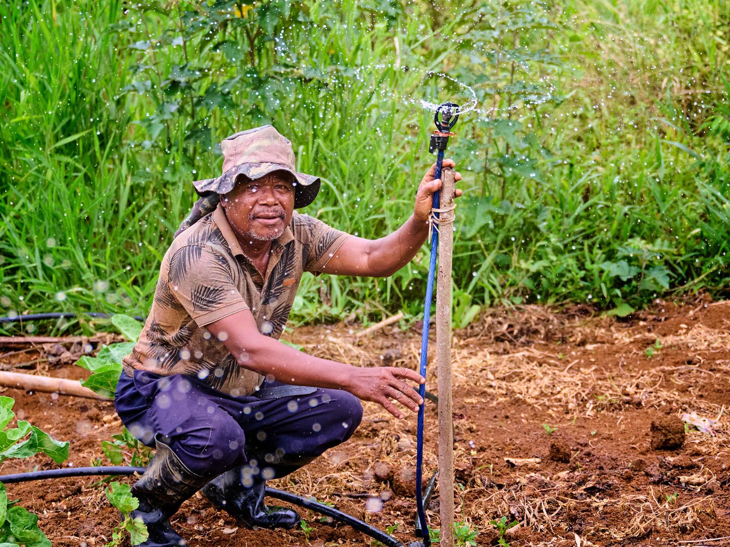 Samllholder farmer with water in a field
