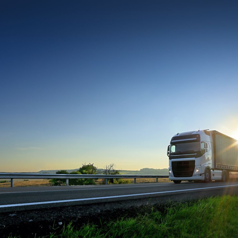 Truck on highway with sun going under