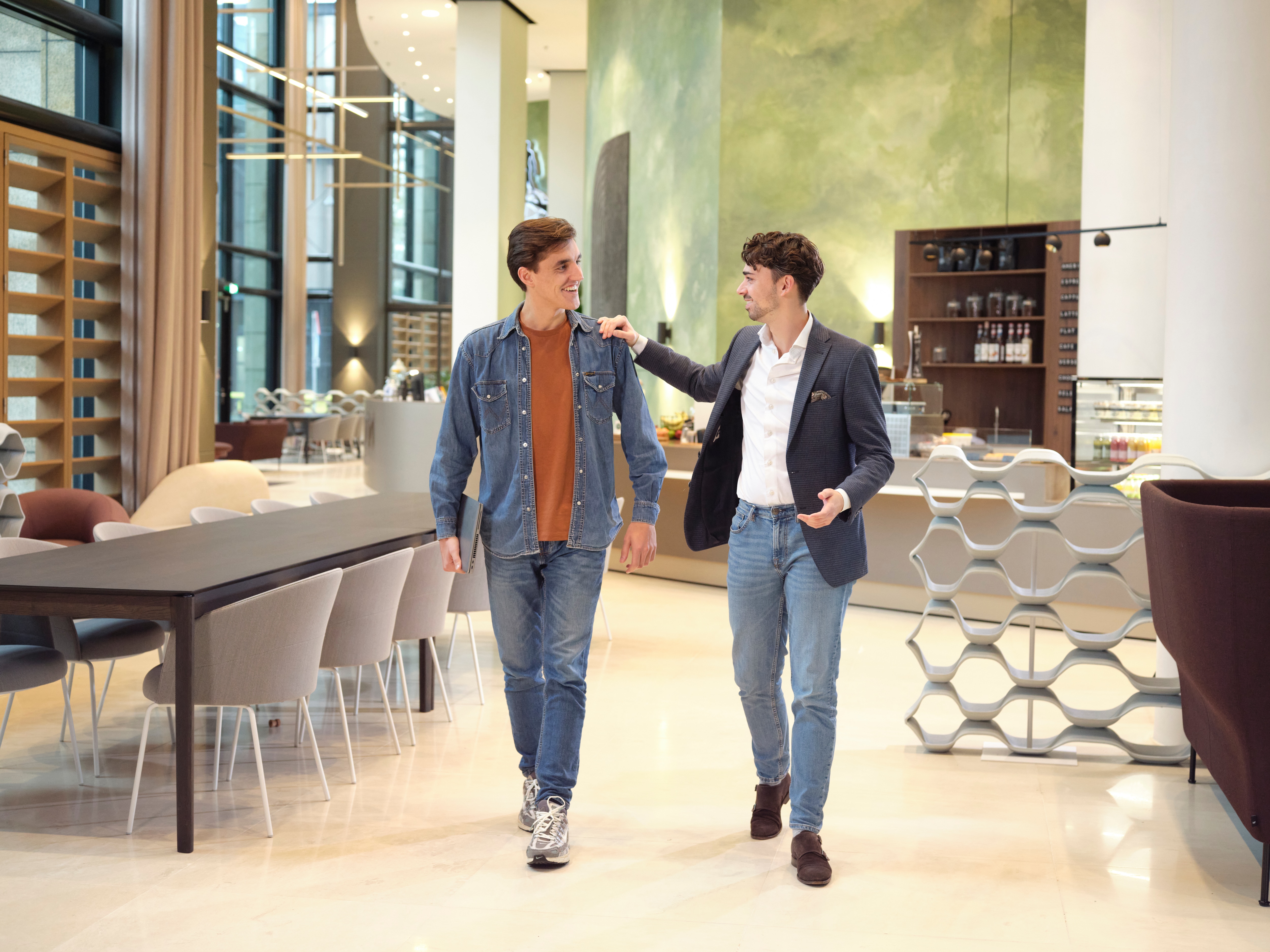 Colleagues chatting and walking through the office